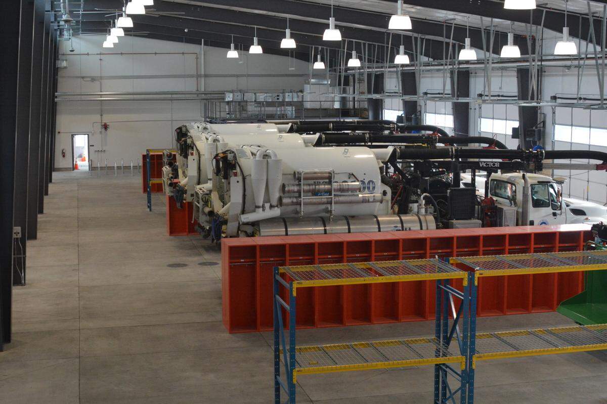 Vacuum trucks are lined up in the city’s new maintenance barn, part of the new $20 million Operations Center that opened in March 2023 in Bellingham. The new maintenance barn includes a washing station for large trucks and has lockers where workers can leave their dirty boots and heavy coats before going inside.