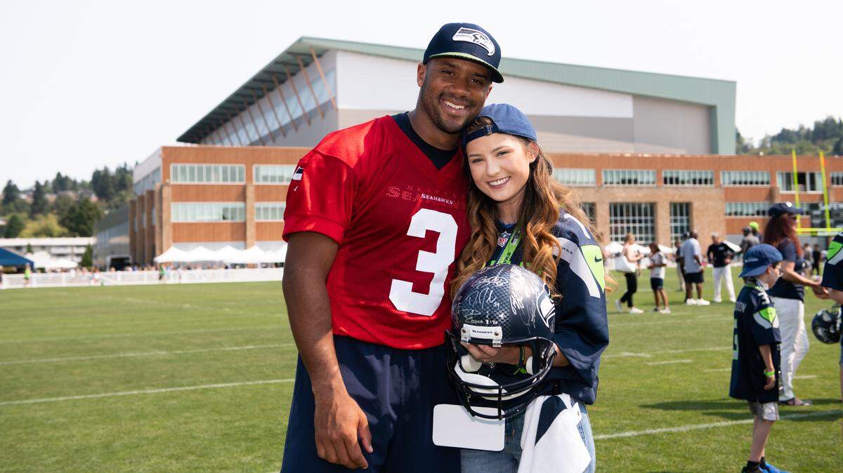 Seattle Seahawks quarterback Russell Wilson spends time with 17-year-old Amber Louden, a senior at Squalicum High, during a Make A Wish visit Aug. 8 at the Seahawks’ training facility in Renton.