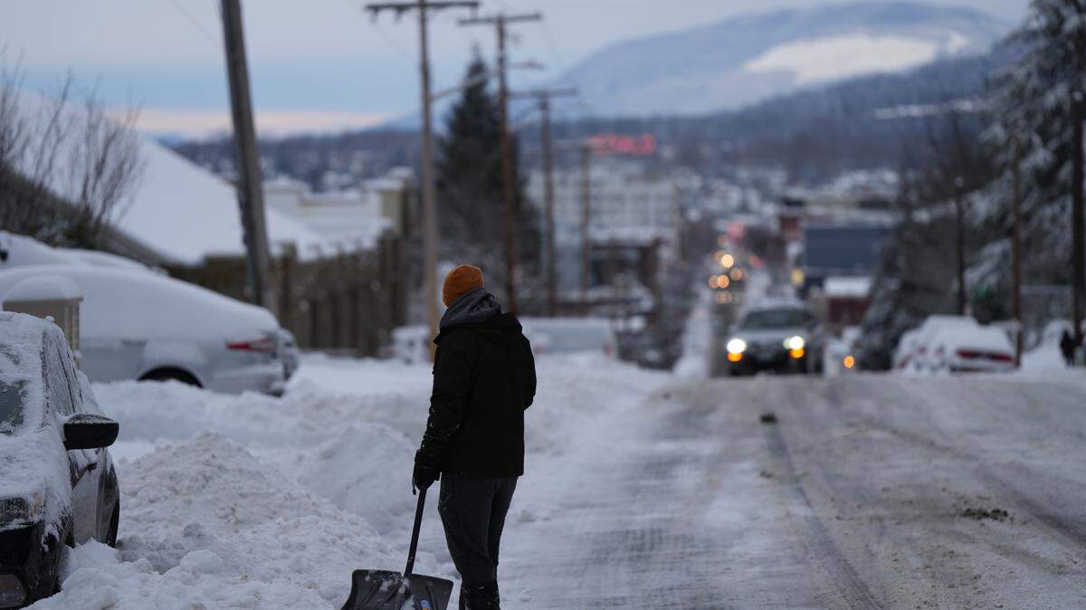 A Bellingham resident shovels snow from a driveway on N State Street on Wednesday, January 17, 2024, after the season’s first major snowfall.