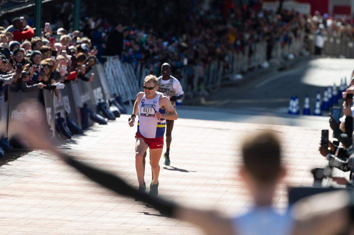 Second-place finisher Jacob Riley, is followed by third-place finisher Abdi Abdirahman as first-place finisher Galen Rupp reacts while waiting for them at the finish line during the U.S. Olympic marathon trials Feb. 29, 2020, in Atlanta.