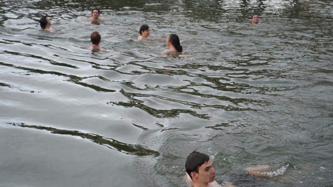 Western Washington University Cold Plunge Club members swim in the water off Taylor Dock on Wednesday, April 29, in Bellingham, Wash.