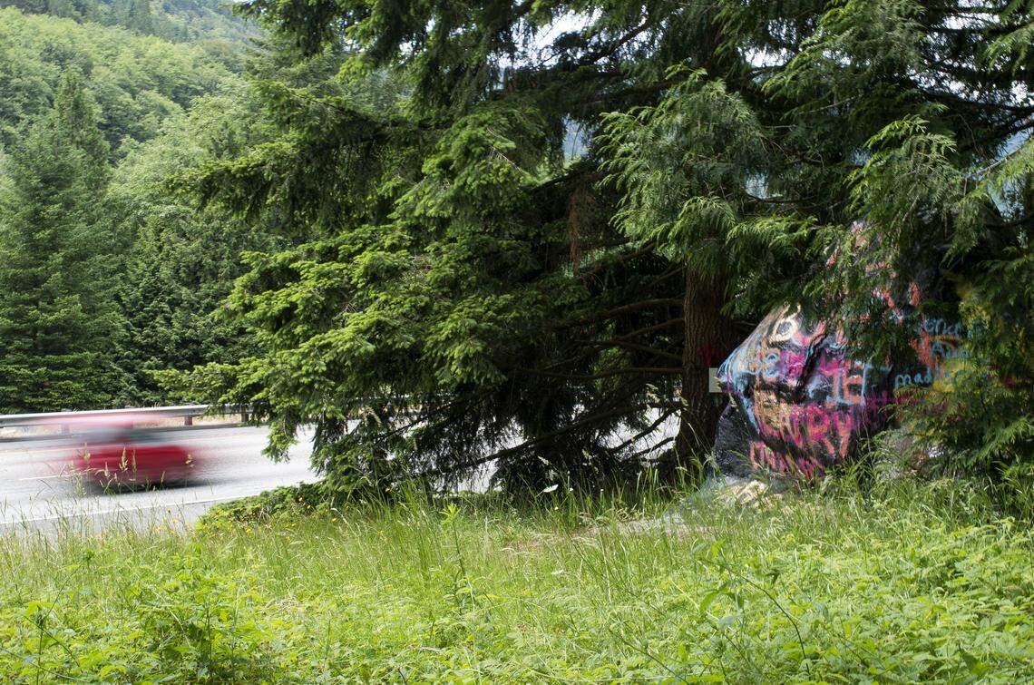 Vehicles travel north on Interstate 5 past the “graffiti rock” near Bellingham.