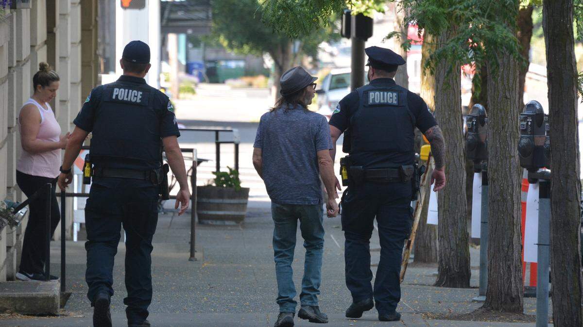 Two Bellingham police officers walk along Cornwall Avenue near Chestnut Street in 2023, as part of occasional foot patrols in the downtown core.