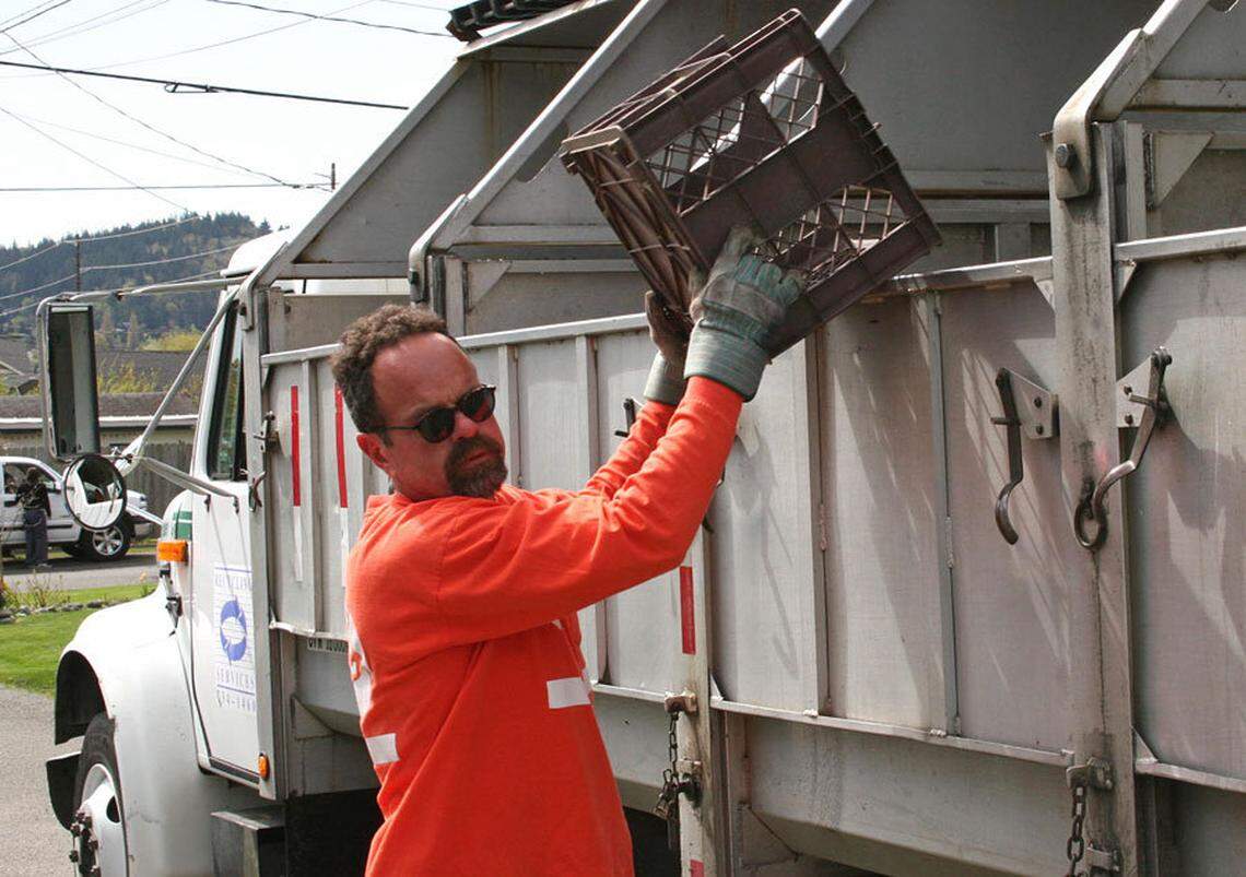 Steven Berry dumps a recycling bin in a Bellingham