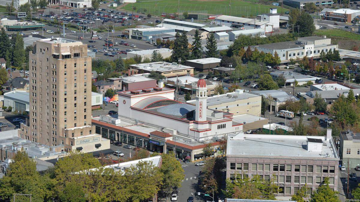The red cupola atop the Mount Baker Theatre stands out on the skyline in downtown Bellingham, Wash. Bellingham Towers is on the left in this aerial photo from 2013.