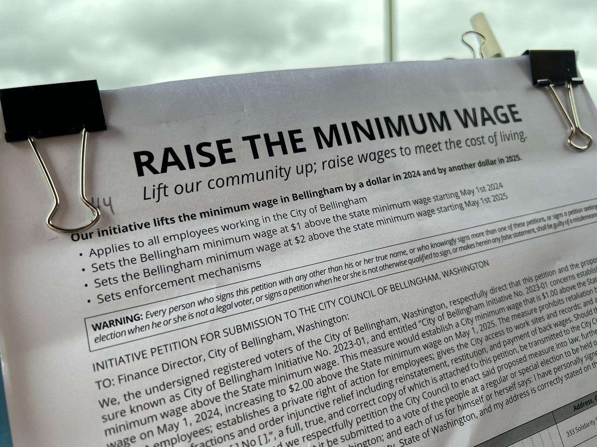 A petition from Community First Whatcom seeks to raise the minimum wage to $1 an hour above the Washington state minimum wage is shown April 9, 2023, outside the Bellingham Food Co-op in the Cordata neighborhood of Bellingham, Washington.