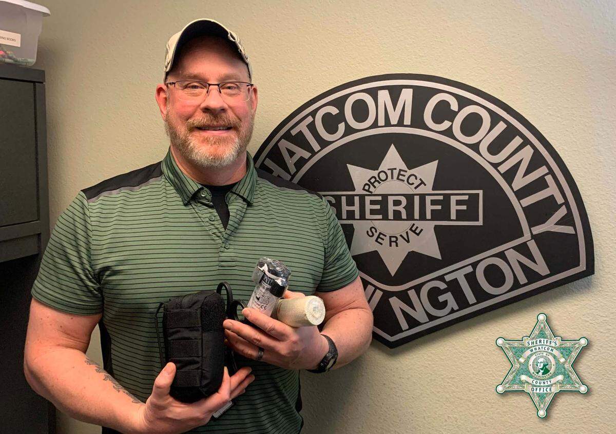 Whatcom County Sheriff’s Office deputy Jason Thompson, one of two deputies shot in the face while responding to a neighborhood dispute on Feb. 10, shows a trauma kit donated by the Foothills Community Alliance.