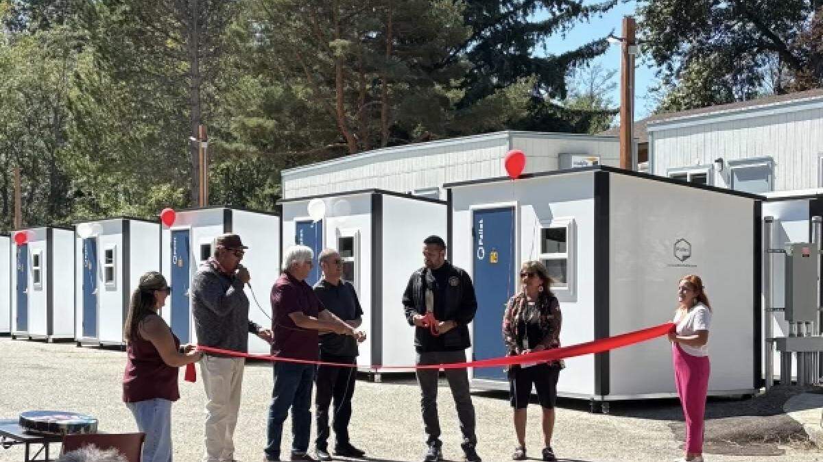 Lummi Nation Chairman Anthony Hillaire prepares for the ribbon-cutting at the grand opening ceremony of the Kwensot Qelat 40-unit transitional housing village.