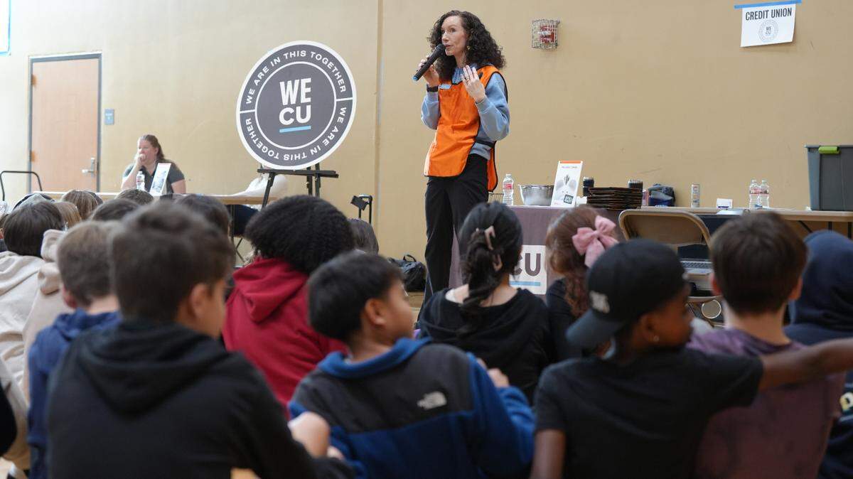 WECU representative Cherish Flint introduces a group of Shuksan Middle School students to “Bite of Reality” on April 1 in Bellingham.