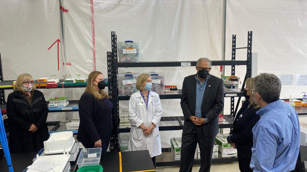 Washington Gov. Jay Inslee, center right, visits Northwest Laboratory to see its testing operations and learn about its work increasing COVID-19 testing capacity on Tuesday, Oct. 12, in Bellingham.