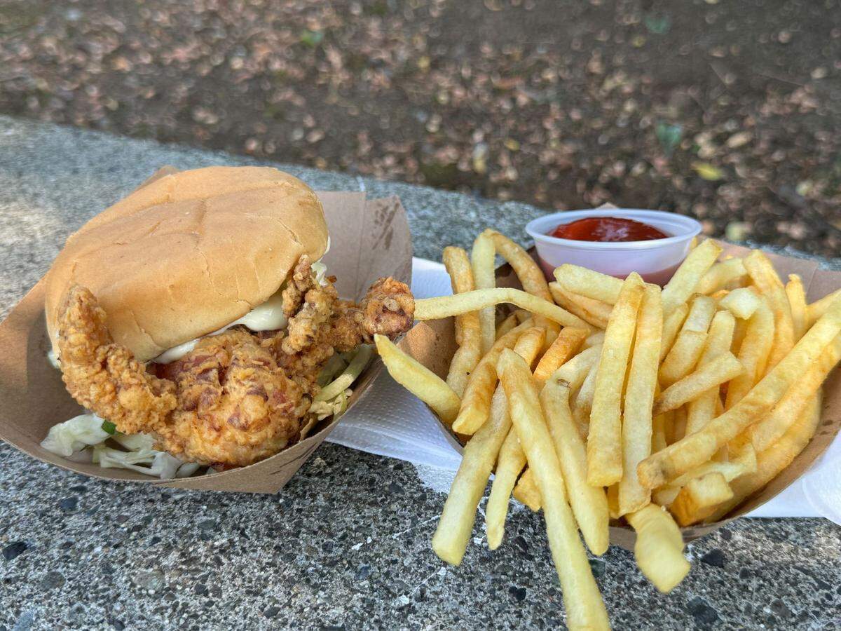A fried chicken sandwich and truffle fries from Feast food truck at The Northwest Raspberry Festival in downtown Lynden, Wash. on Friday, July 19, 2024.