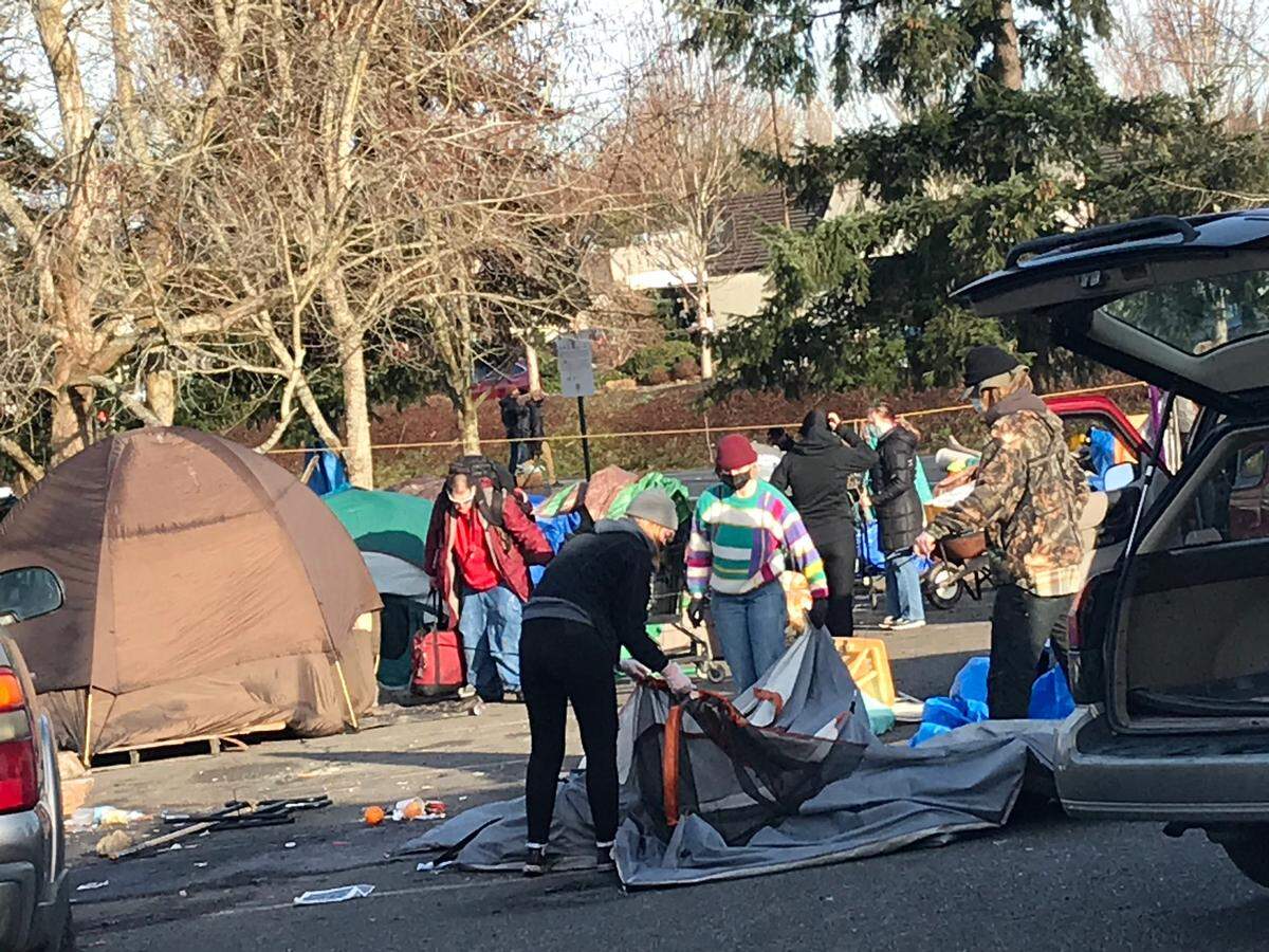 Homeless people, volunteers and crews from Public Works and the Parks and Recreation Department began dismantling a homeless camp at Frank Geri Softball Fields in Bellingham on Tuesday, March 16.