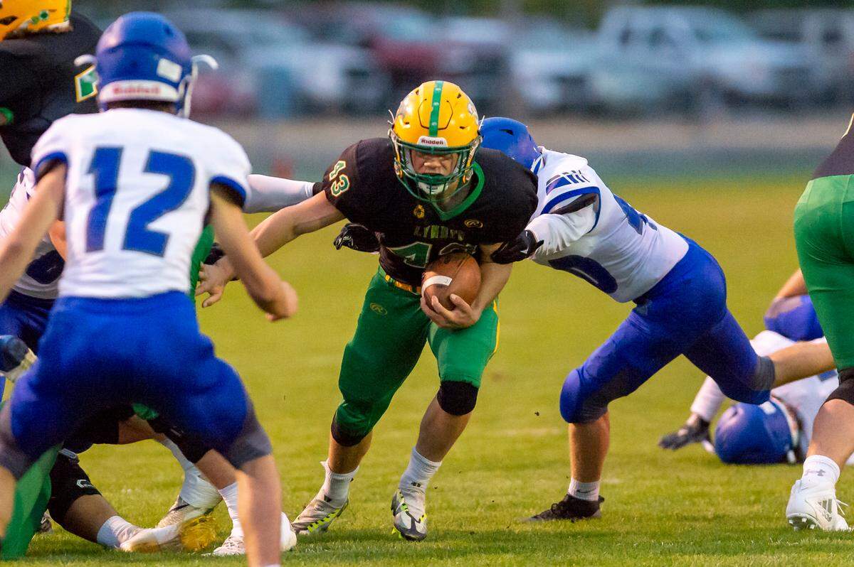 Lynden running back Lane Heeringa (43) moves through the line of scrimmage for a short gain during the first quarter on Friday evening, Sept. 23, at Lynden High Schoo. Lynden continued its undefeated season winning 24 to 21 over Sedro-Woolley with a last minute touchdown.