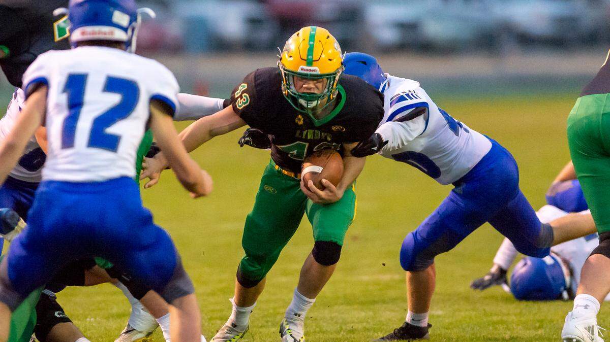 Lynden running back Lane Heeringa (43) moves through the line of scrimmage for a short gain during the first quarter on Friday evening Sept. 23, at Lynden High School in Lynden.