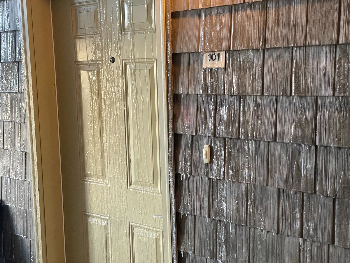 Water from a burst fire sprinkler is frozen on the exterior of an apartment door at the Meadow Wood townhomes in Bellingham, Wash.