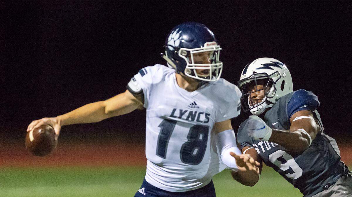 Squalicum linebacker Djouvensky “Ben” Schlenbaker (9) sacks Lynden Christian quarterback Will Colwell (18) for a loss early in the second quarter on Friday evening Sept. 3, at Civic Field in Bellingham.
