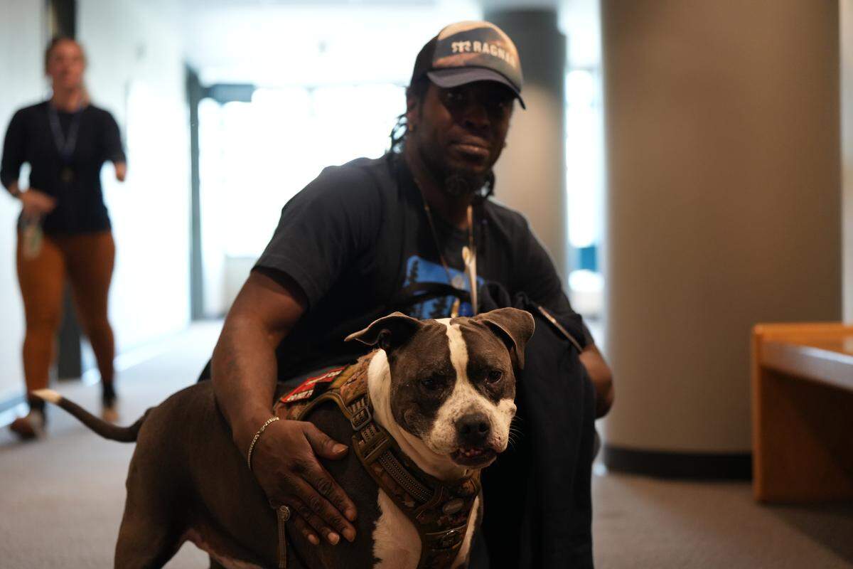 A Whatcom County Mental Health Court (MHC) participant posed with his dog after the proceedings on October 1, 2025, in Bellingham, Wash.