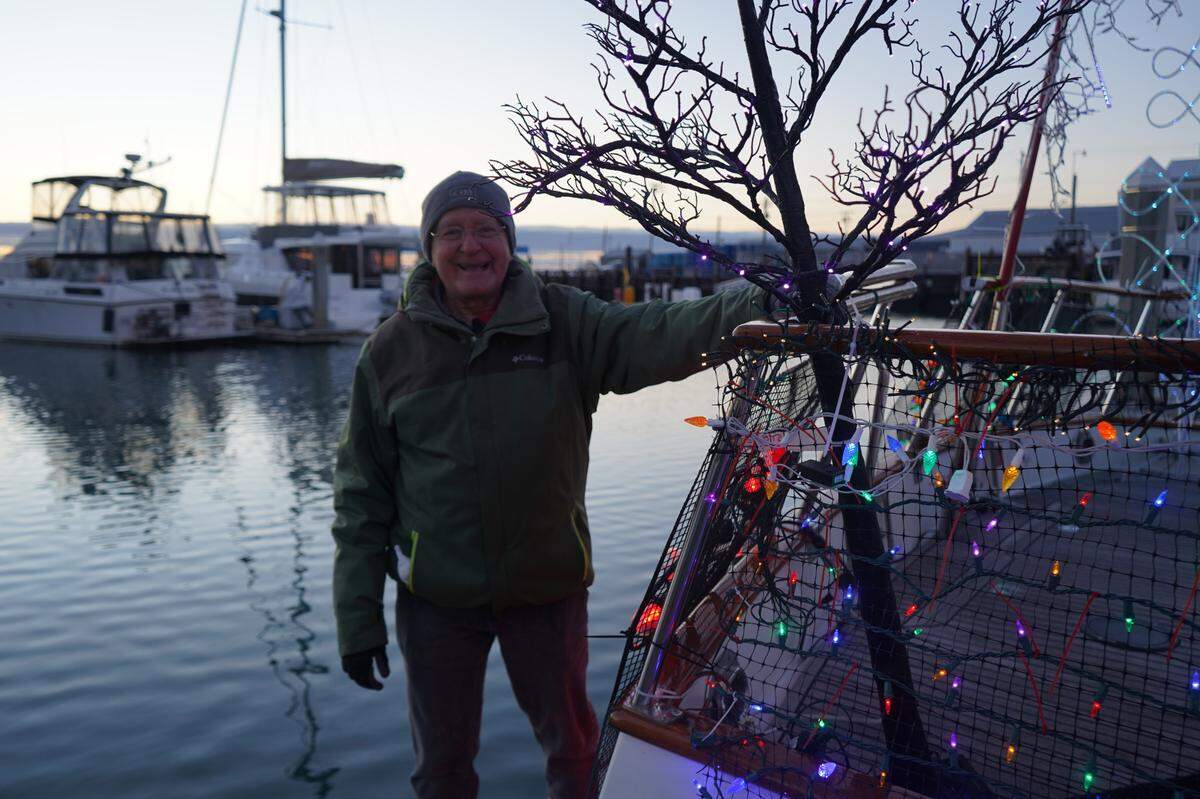 Dan Ringler stands in front of his boat, Seahome, Thursday, Dec. 1, in Bellingham. Seahome is decorated with about 7,000 LED lights for the annual Bellingham Yacht Club lighted boat parade.