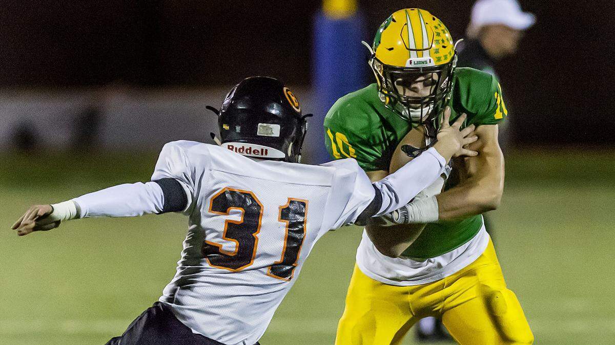 Blaine defender Seth Blomeen (31) attempts to stop Lynden quarterback James Marsh on Nov. 2. The Lions face Fife in the state quarterfinals Saturday.