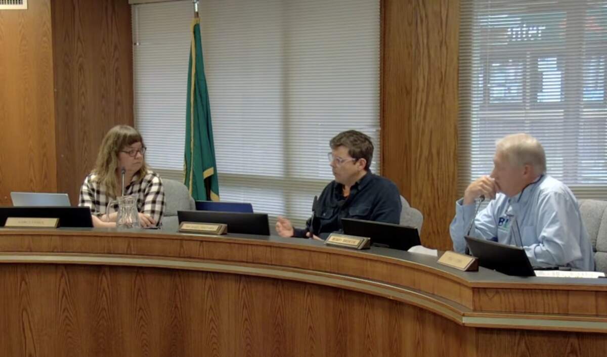 Port of Bellingham Commissioners (from left) Carly James, Michael Shepard and Bobby Briscoe discuss a resolution on June 9 to prevent Port property from being used for civil immigration detention facilities or civil immigration enforcement support facilities. The Commission voted 2-1 to adopt the resolution.
