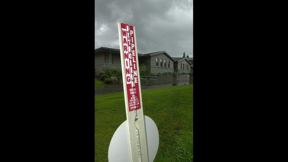An Olympic Pipeline marker shows how close the pipeline is to Kulshan Middle School. The pipeline runs aproximately 30 feet to the west of the school building.