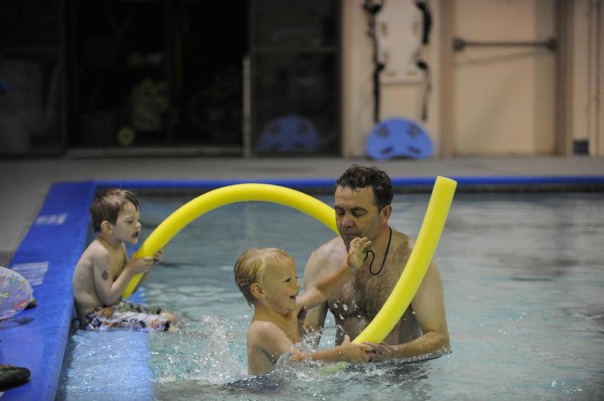 Swimming instructor Vitaliy Bondarchuk helps Aiden Dodd, then 3, jump into the water, while Magnum Wanderscheid, 3, waits his turn during swim lessons at the Lynden YMCA in June 2013.