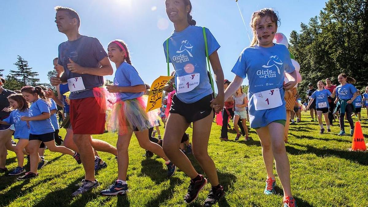 Participants take off from the start during the 2016 Girls On The Run 5K on Saturday morning June 4, 2016, at Lake Padden in Bellingham. Girls On The Run director Jen Gallant said over 700 people registered for the fun run, including 400 participants in the Girls On The Run and Trail Blazer programs as well as 300 adults from various YMCAs around the Puget Sound. Girls On The Run is a YMCA after-school program designed to encourage positive emotional, social, mental, spiritual and physical development.