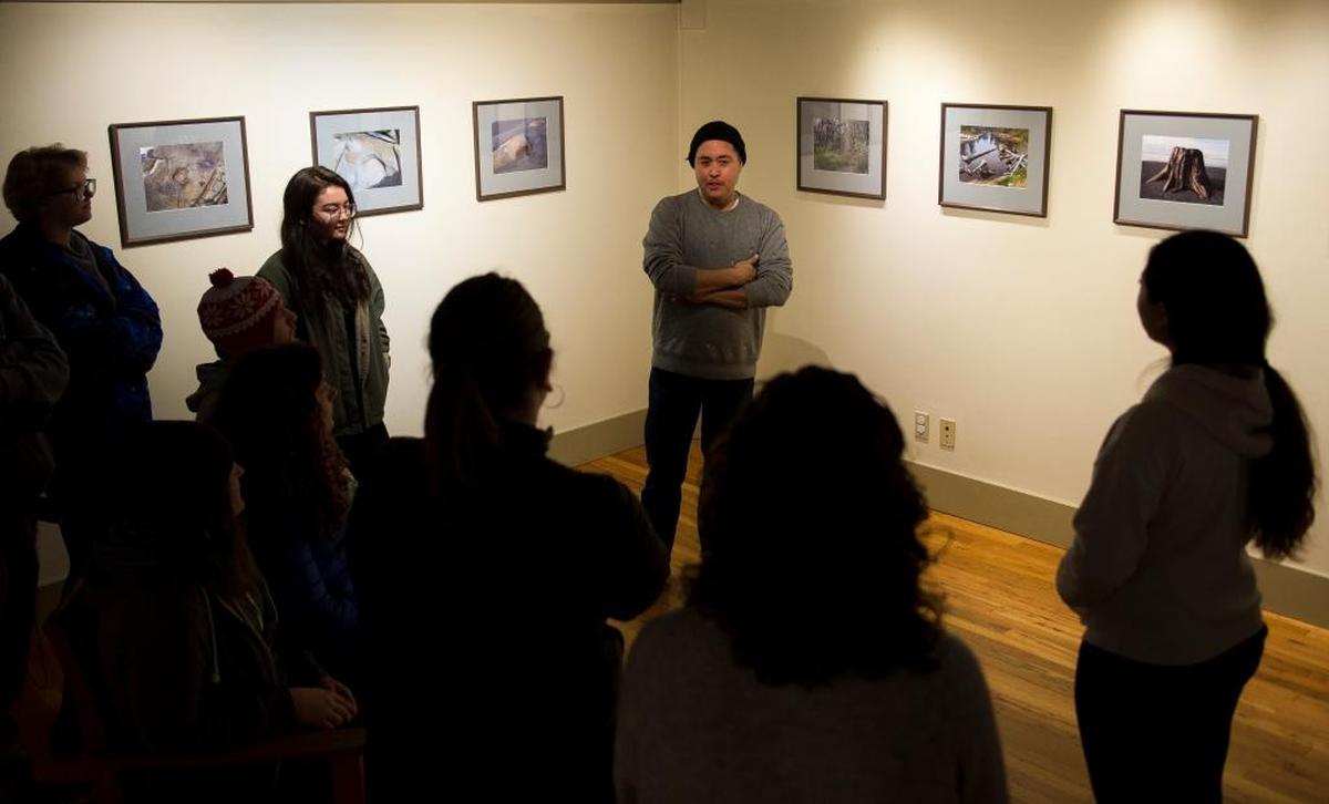 Chris Vargas, professor of a 2D foundations art class at Western Washington University, speaks to his class during a field trip at Mindport Exhibits Feb. 8 in Bellingham.