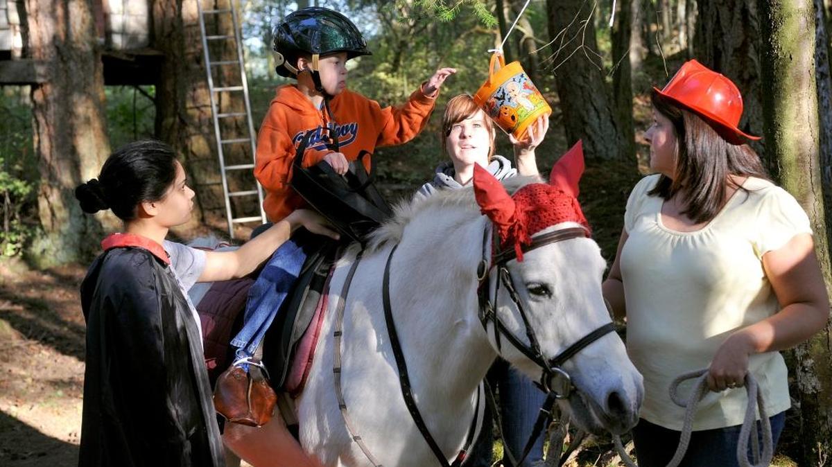 The Northwest Therapeutic Riding Center hosts a trick-or-treating in the woods event in 2010. The center teaches horsemanship and riding adapted as needed for each individual, with about 40 percent of riders on the autism spectrum and about 60 percent with developmental delays.