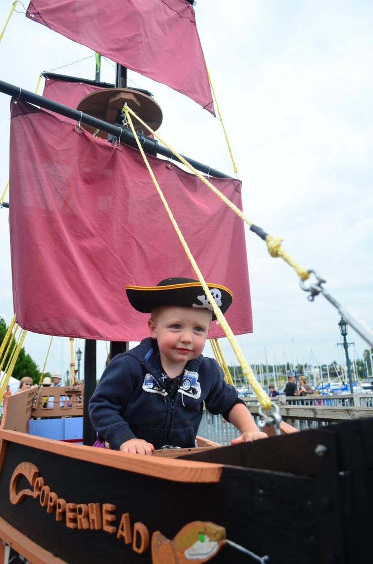Drayton Simpson, 2, looks over the bow of a float in August 2013 at the Drayton Harbor Days Maritime Festival in Blaine.