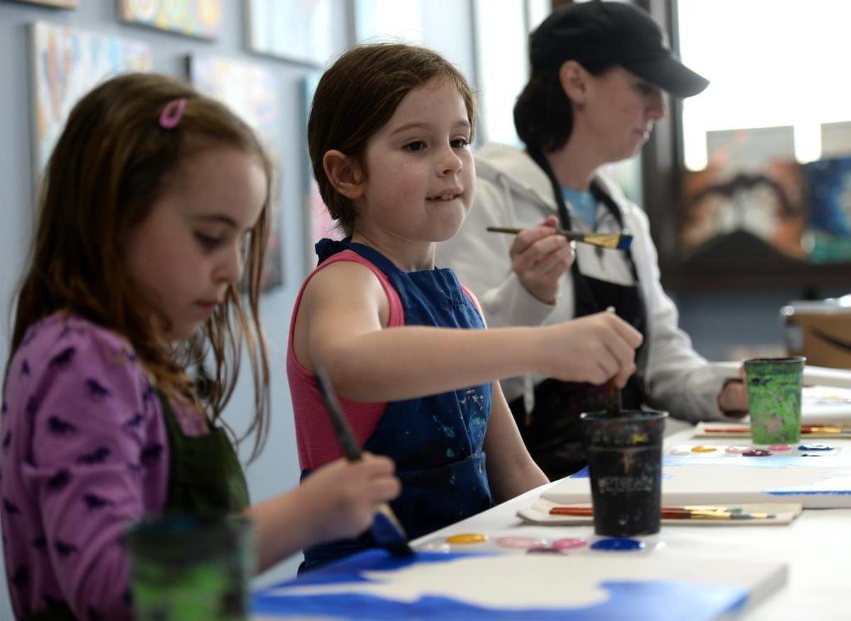 Raegan Wheeler, 8, left, Kaitlyn Andrews, 8, and Kaityn's mom, Karen Andrews, paint portraits of a unicorn at the new location of Uptown Art studio at 800 Harris Ave., No. 101 in the Fairhaven District of Bellingham, Thursday, April 13. The paint and sip art studio is having an open house at 3 p.m. on Thursday, April 27.