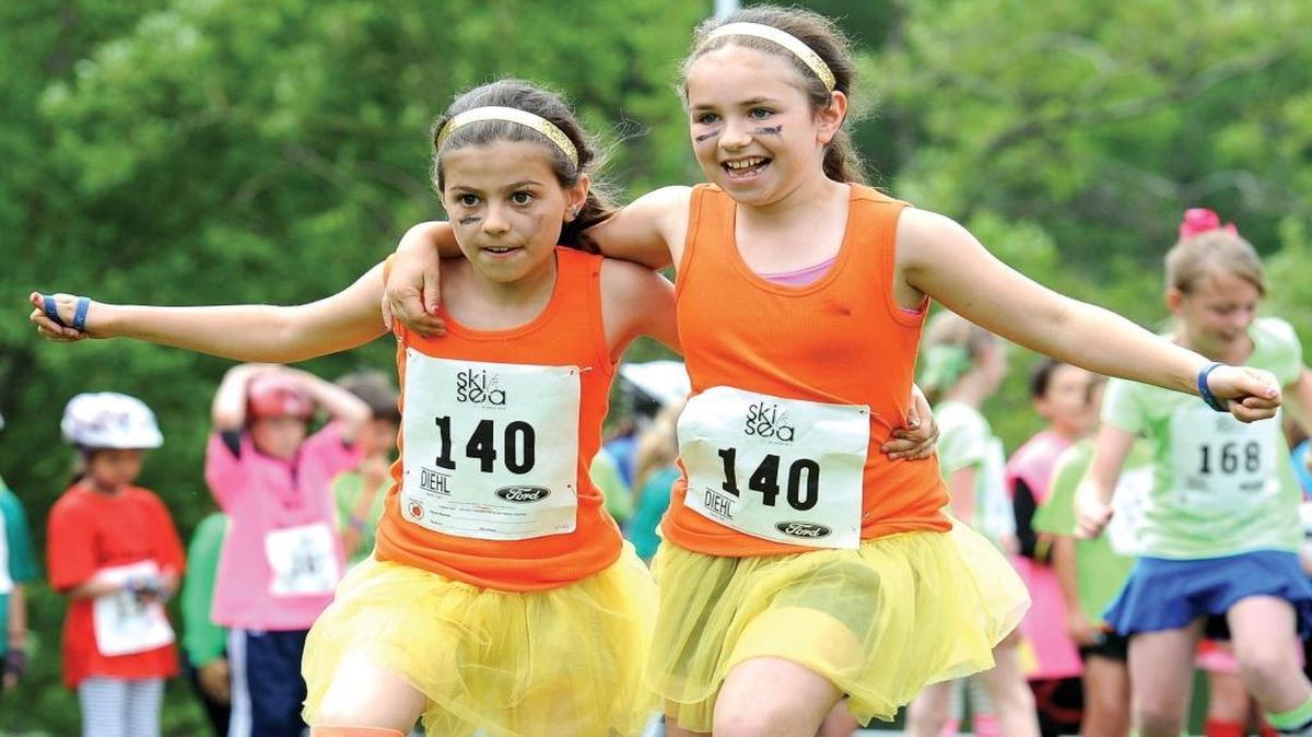 Chelan Howard and Keira Woolman compete in the three-legged race as part of team Golden Sunshine Tough Girls in the 2014 Junior Ski to Sea Race. Junior Ski to Sea will replace the three-legged race with a Hula Hoop race in 2017. Both racers will run while inside a Hula Hoop.