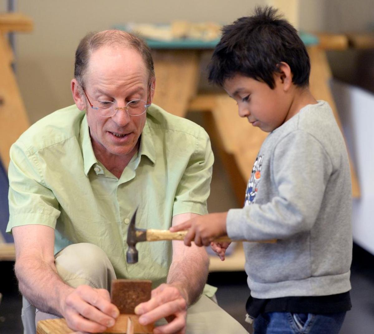 Instructor Alex Brede shows Jacob Martinez, 5, how to use a hammer during the After School Enrichment woodworking class at Cordata Elementary in Bellingham, Wednesday, June 7.