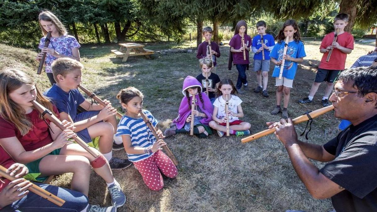 Peter Ali, right, a flute instructor at the Northwest Indian College on the Lummi reservation, improvises a song with Waldorf School students. Music is an important element of the Waldorf curriculum.