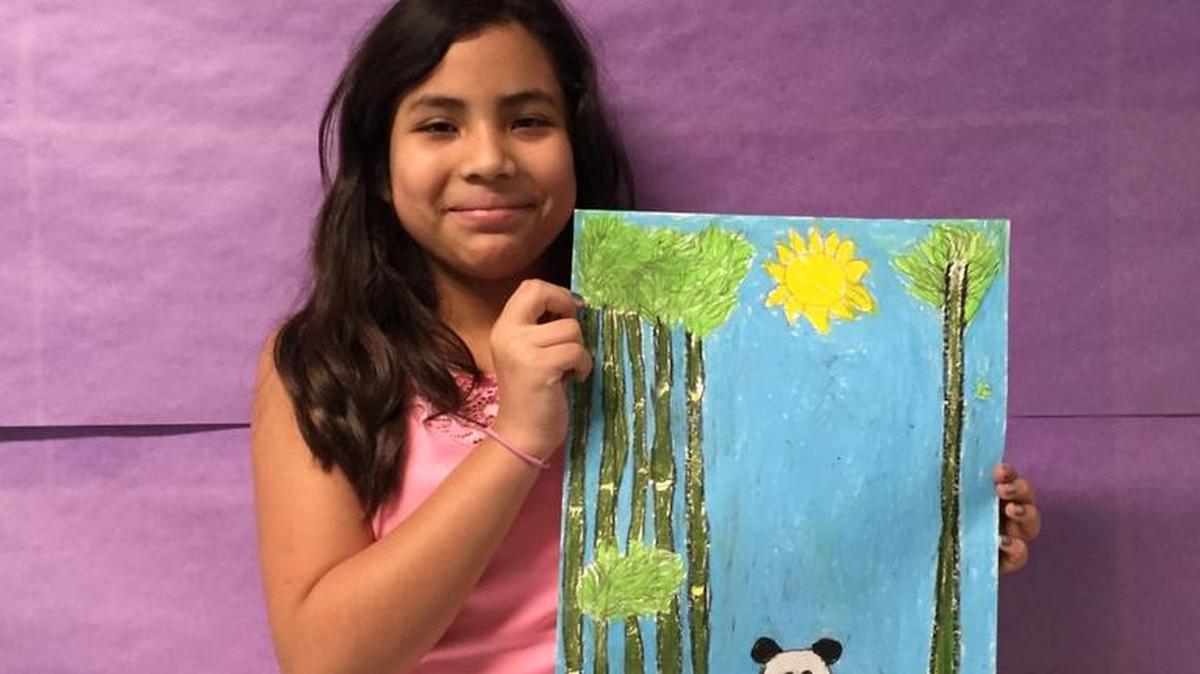 Artist Emily Paz, 10, a fourth-grader at Carl Cozier Elementary School, displays one of her works.
