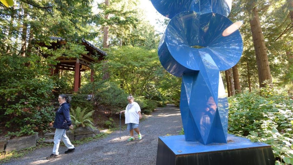 Jackie Kemper, left, and Jo Brown, both of Sedro-Wooley walk by “lipschitziana” a sculpture by the artist Sebastián at Big Rock Garden Park on Alabama Hill in Bellingham, Wednesday, Sept. 14, 2016.