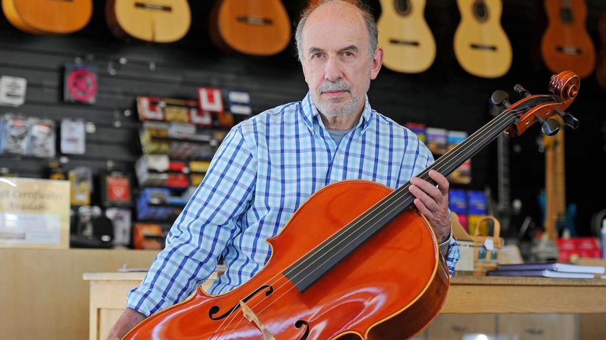 
Bellingham Music owner Ron Rondello holds one of the cellos that he rents to students from his music store. The store also sells musical instruments and offers lessons.
