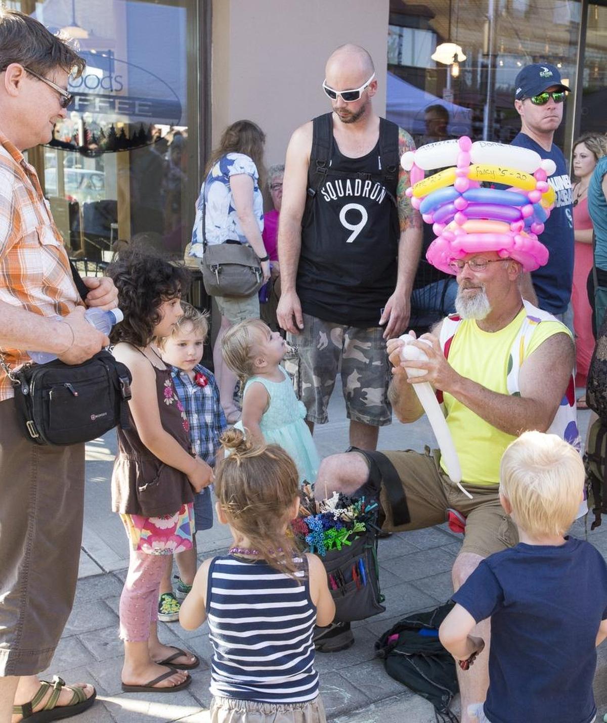 Children wait for creations from a balloon artist at Downtown Sounds in Bellingham.