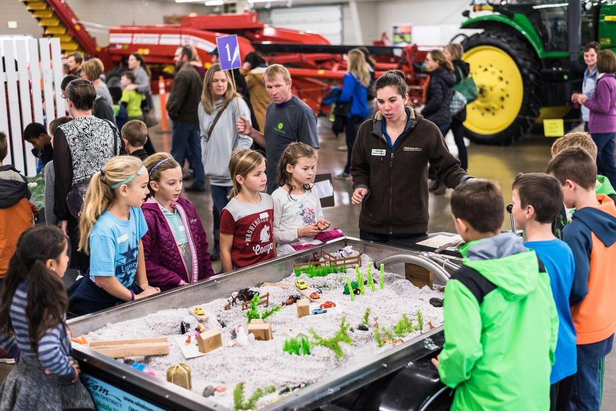 Corina Cheever, farm planning coordinator for the Whatcom Conservation District, talks to children during the Whatcom Farm Circle’s three-day educational event for third-graders at the Northwest Washington Fairgrounds.