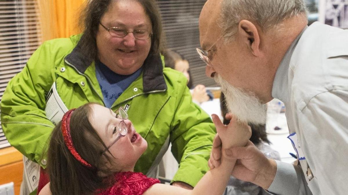 Lauren Gongwer, left, plays with Bill Lay’s beard at The ARC of Whatcom County's 2015 Smiles of Life calendar release party at the Squalicum Boathouse in Bellingham.