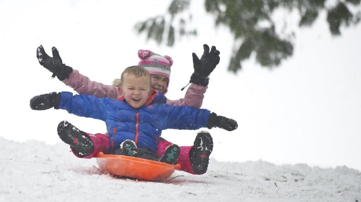 Children sled at Lynden City Park in 2013. The park offers an incline that has been a local favorite of sledders for years, although the 2006 addition of the Million Smiles Playground shortened the ride a bit.