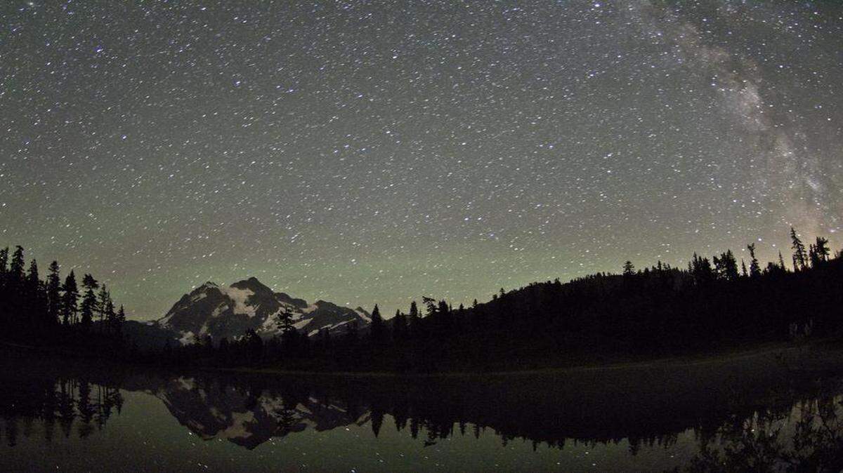 
A long-exposure photograph of Mount Shuksan shows the Milky Way galaxy from Picture Lake near Artist Point in August 2014.

