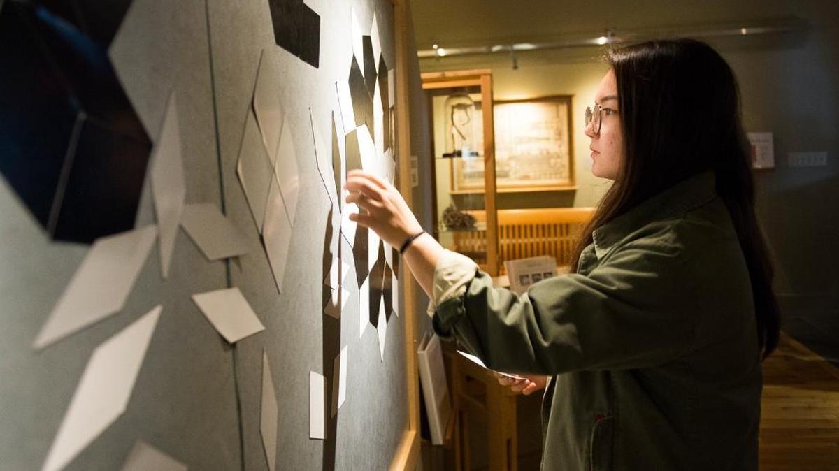 Elly Minagawa plays with Penrose tiles at Mindport Exhibits Feb. 8 in Bellingham.