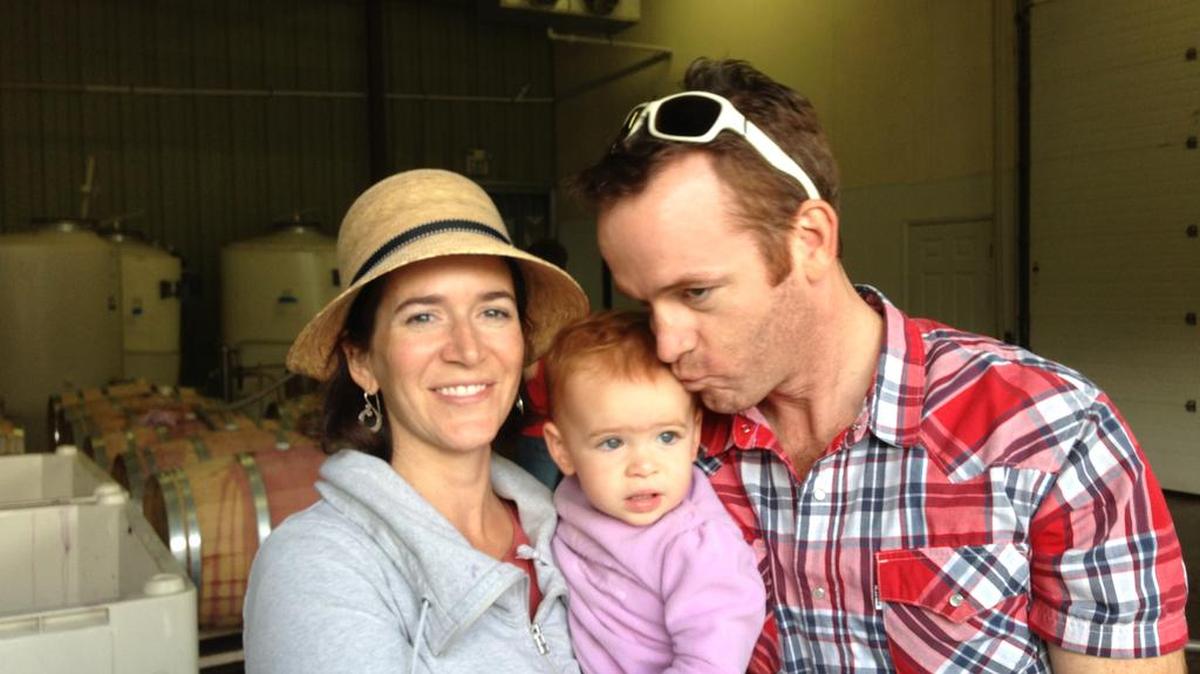 Cinder Wines co-owners Melanie Krause and Joe Schnerr hold their daughter, Sam, at the winery in Garden City, Idaho.