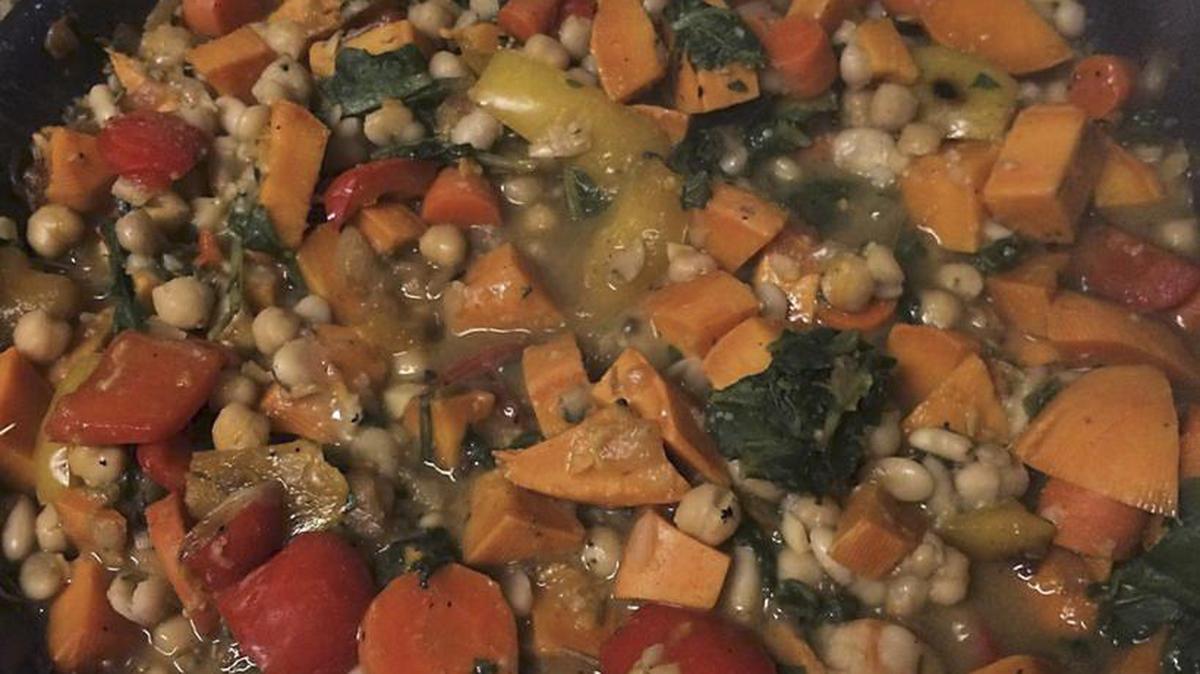 Vegetable White Bean Hash simmers on the stove. The recipe is from the Forks Over Knives website.