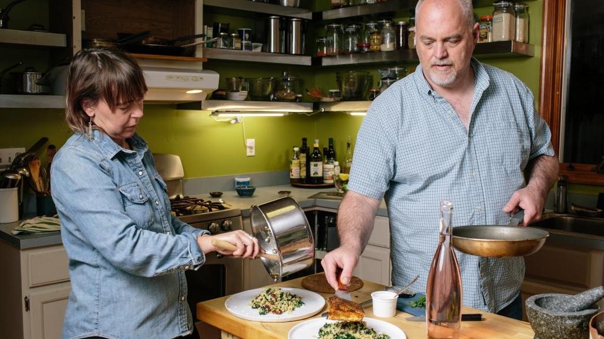 Leslie Grove, left, and Taylor Hale serve up the results after making Blue Apron’s sumac-spiced salmon meal kit, at their home in Preston, Md., on March 30. In the span of a few short years, more than 100 companies have jumped into the meal kit game.