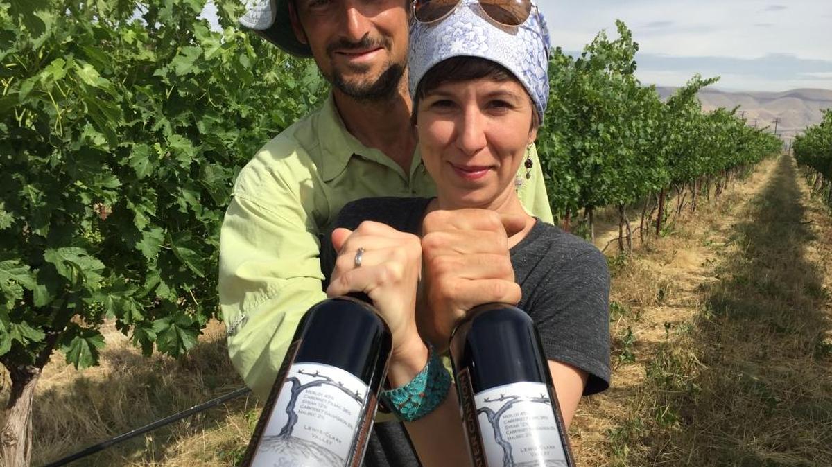 Karl and Coco Umiker stand in their Lewiston, Idaho, vineyard holding bottles of Clearwater Canyon Cellars 2013 Selway Red Wine, which won a double gold at the prestigious 2016 San Francisco International Wine Competition.