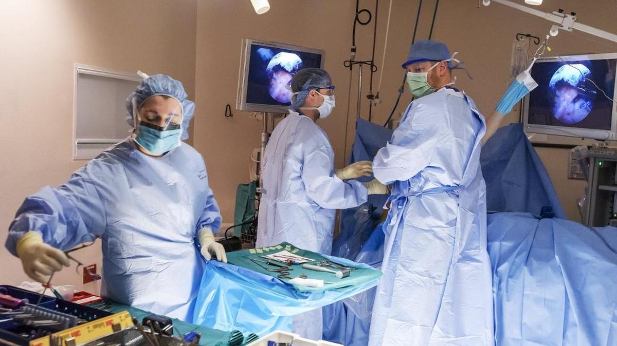 Doctors and nurses perform rotator cuff surgery on a patient at Pacific Rim Outpatient Surgery Center in 2017.