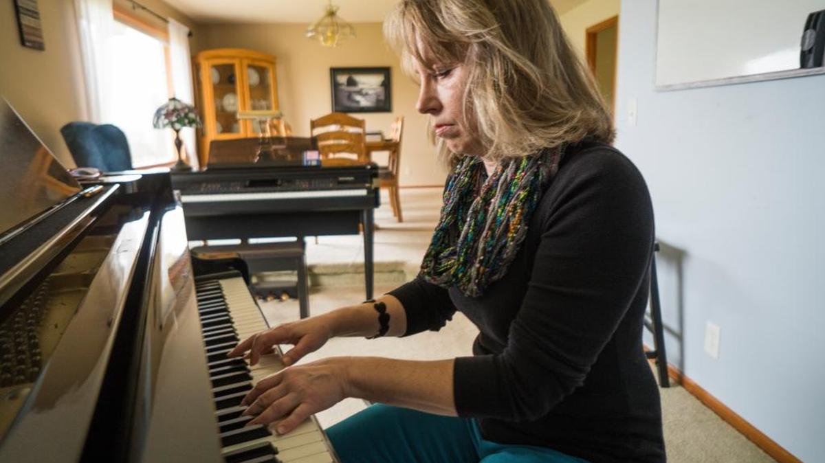 Marianne Brudwick, director of a support group for those who have lost loved ones to brain cancer, plays the piano Feb. 27 in her Ferndale house. She hosts the group at her home so they're able to play piano together.
