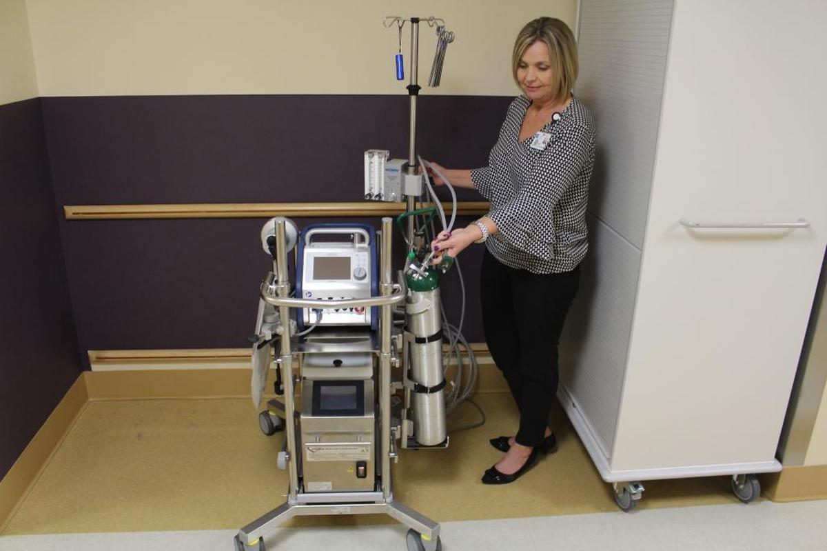 Cindy Gunderson, administrative assistant at the PeaceHealth St. Joseph Cardiovascular Center, shows the ECMO.